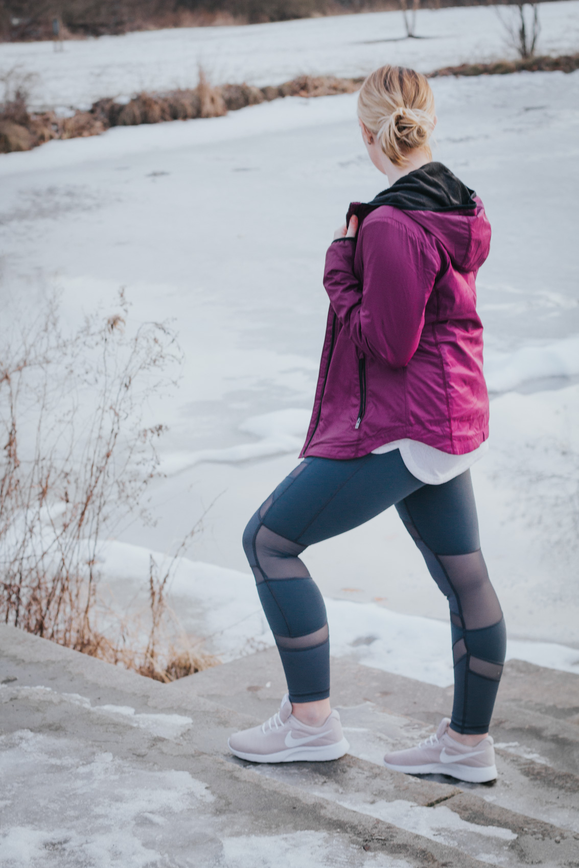 Lifestyle blogger, Allyn Lewis of The Gem, styles a winter workout look with a purple Columbia Sportswear jacket and CALIA by Carrie Underwood leggings.
