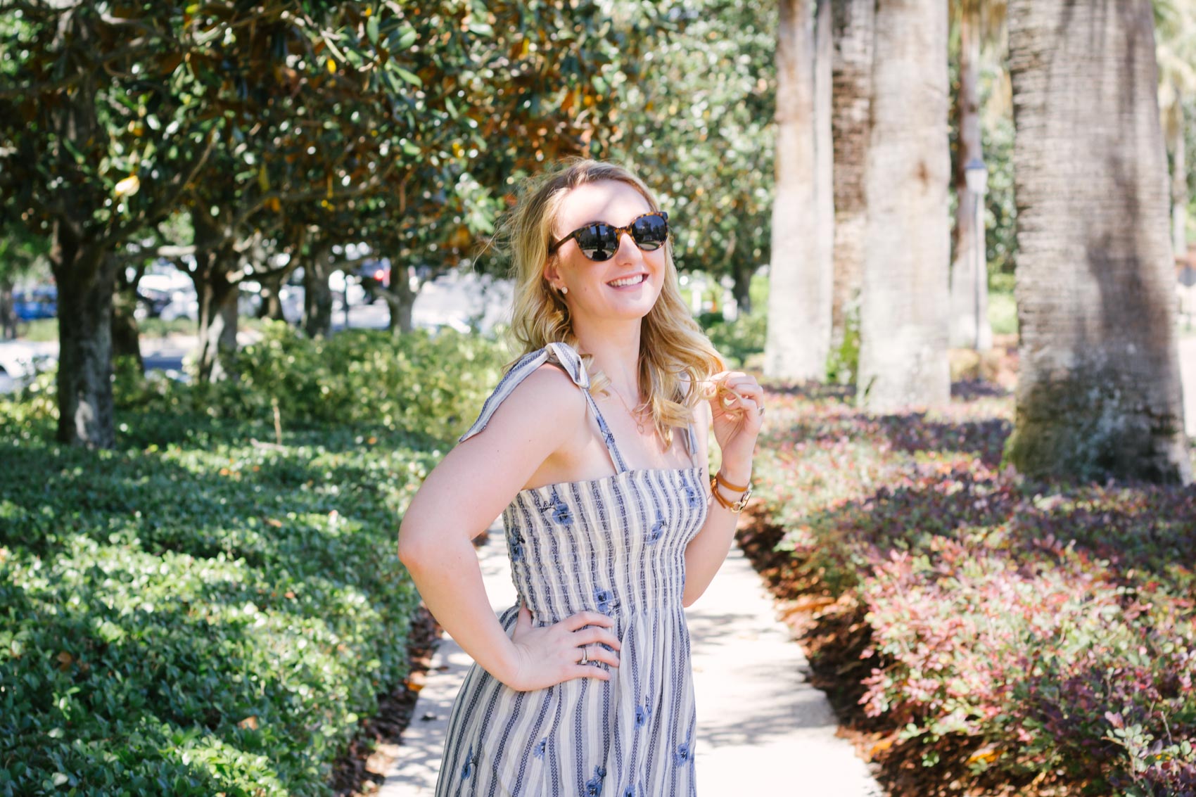 In this summer outfit, lifestyle blogger Allyn Lewis of The Gem styles a playful blue striped dress for a casual look. 