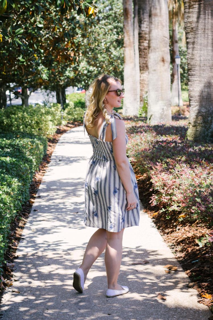 In this summer outfit, lifestyle blogger Allyn Lewis of The Gem styles a playful blue striped dress for a casual look.