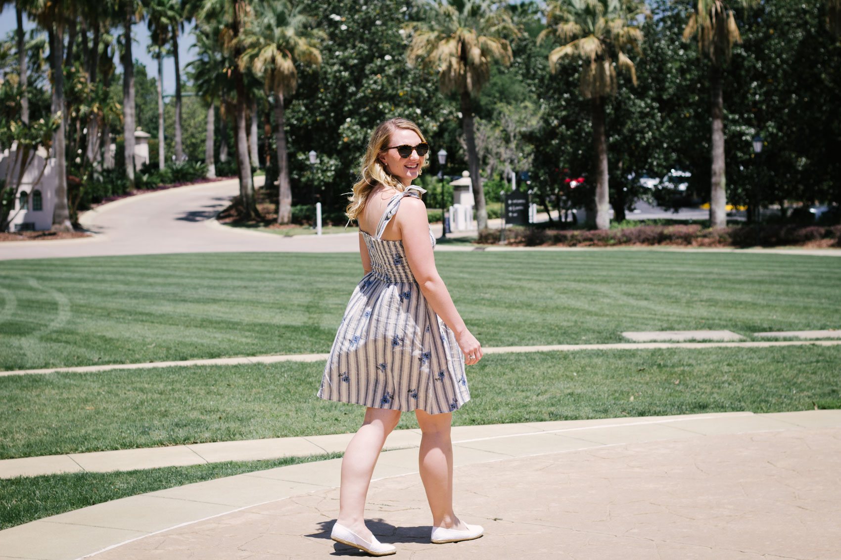 In this summer outfit, lifestyle blogger Allyn Lewis of The Gem styles a playful blue striped dress for a casual look.  