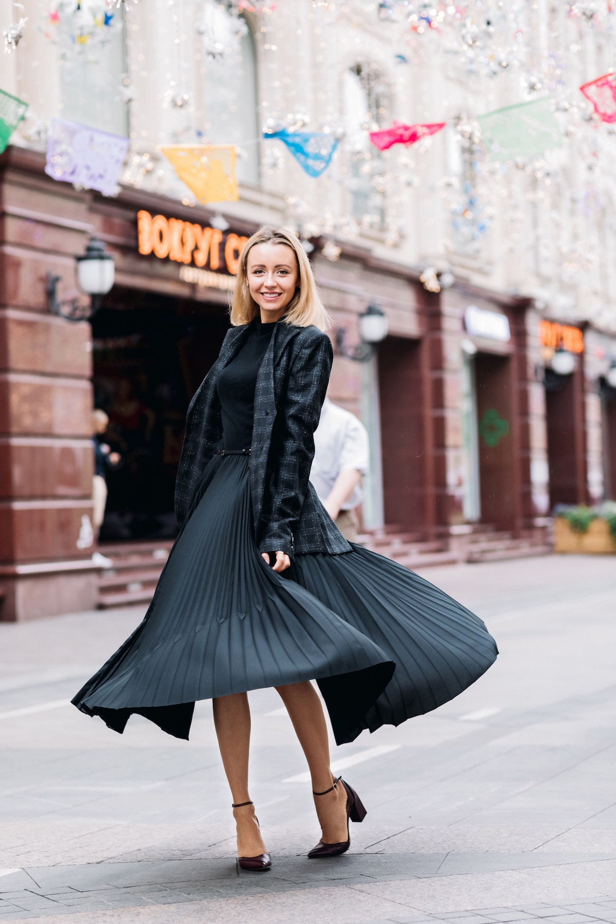 Striking the perfect balance between exposing a little bit of leg but being covered up enough for cooler temperatures, a midi skirt can be dressed up or down for any occasion and are perfectly on trend this autumn. | Photo by Vicky Cheng on Unsplash