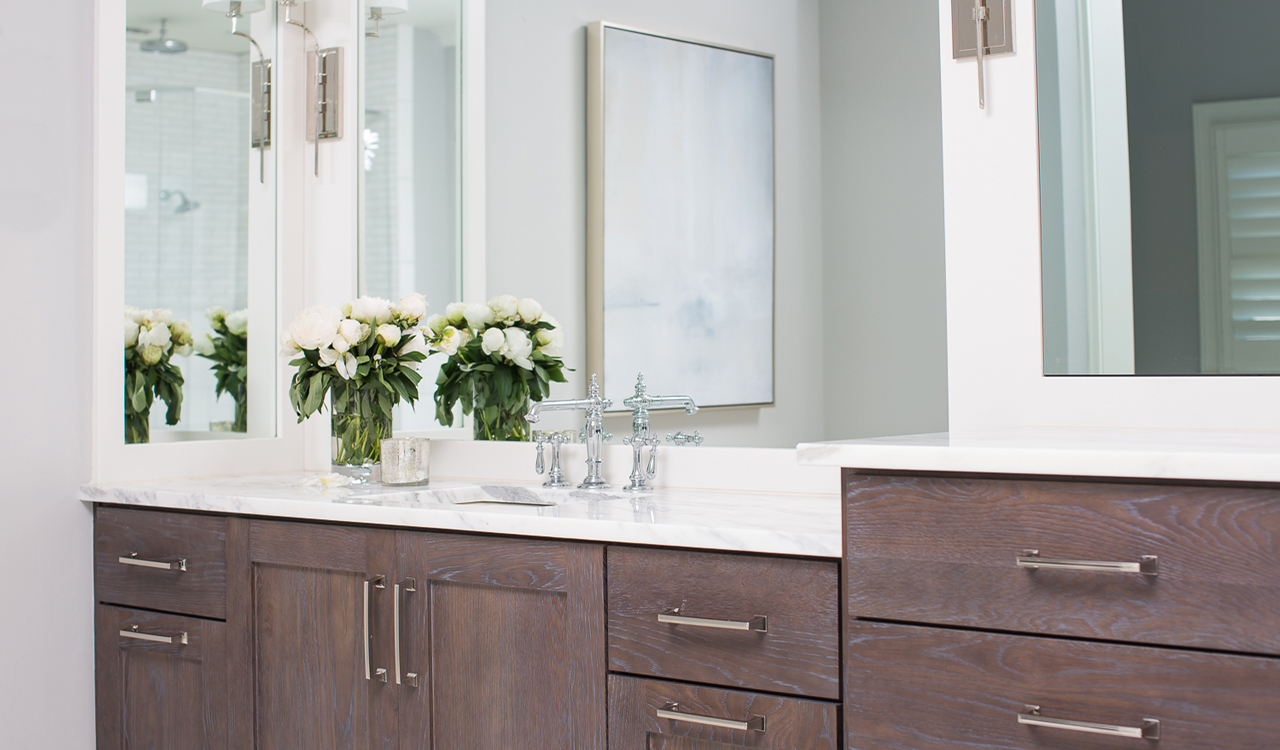 Natural stone countertops and brown cabinets for a beautifully modern bathroom