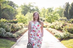 Enjoying the rose garden in a floral Gal Meets Glam Collection jumpsuit