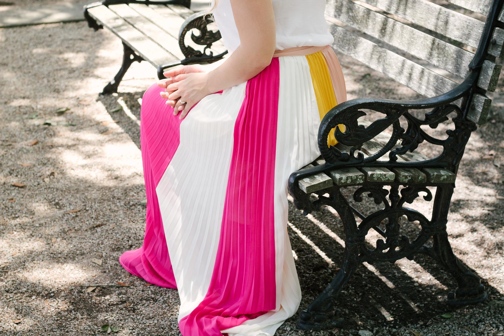 Easy summer outfit: Fashion blogger Allyn Lewis pairs a color blocked pleated skirt with a fresh white cami for an effortless look while exploring Charleston, SC. 