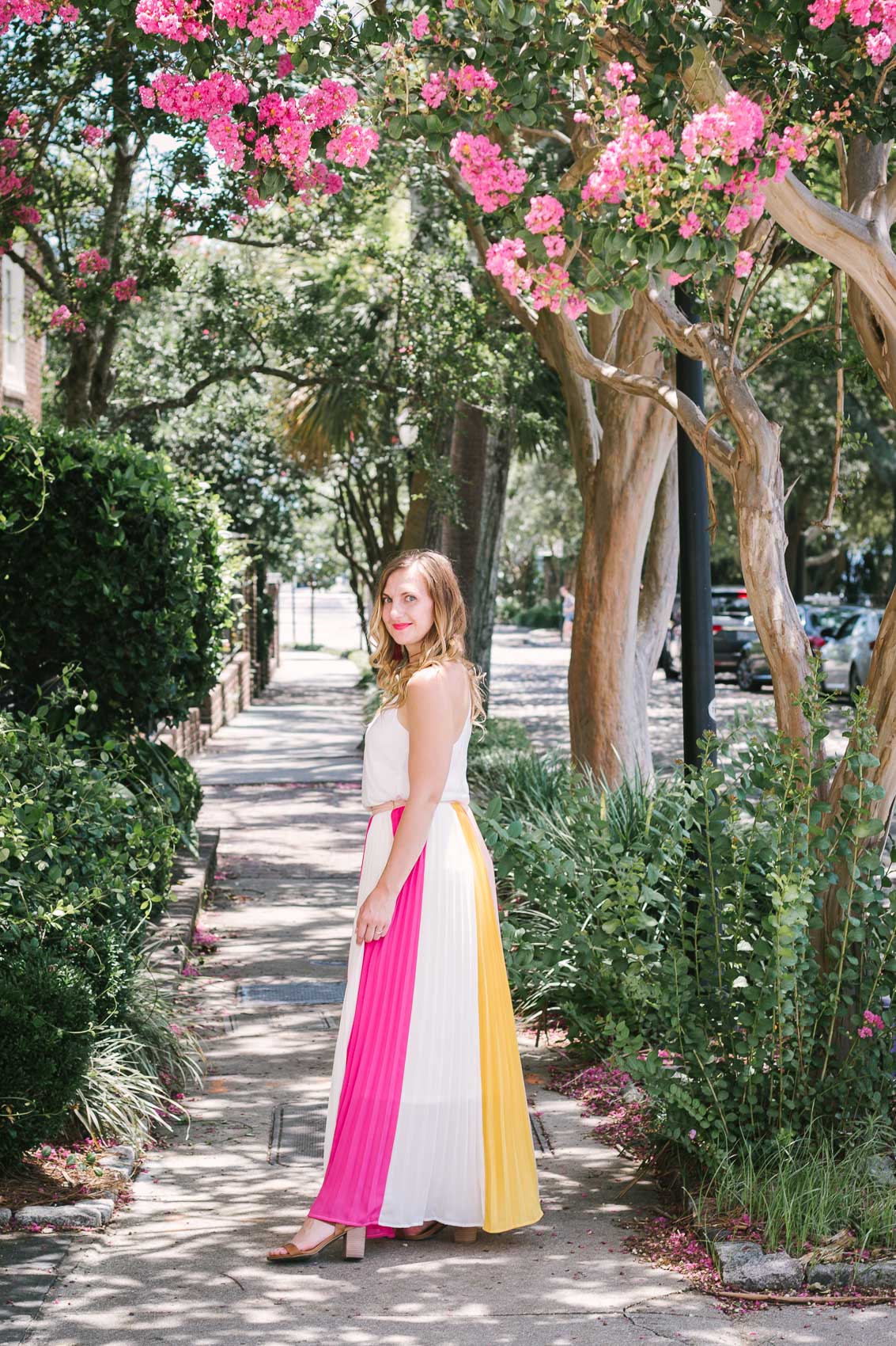 Fashion blogger Allyn Lewis styles a color blocked pleated maxi skirt for a day exploring Charleston, SC. | How to style a pleated maxi skirt | summer outfit inspiration 