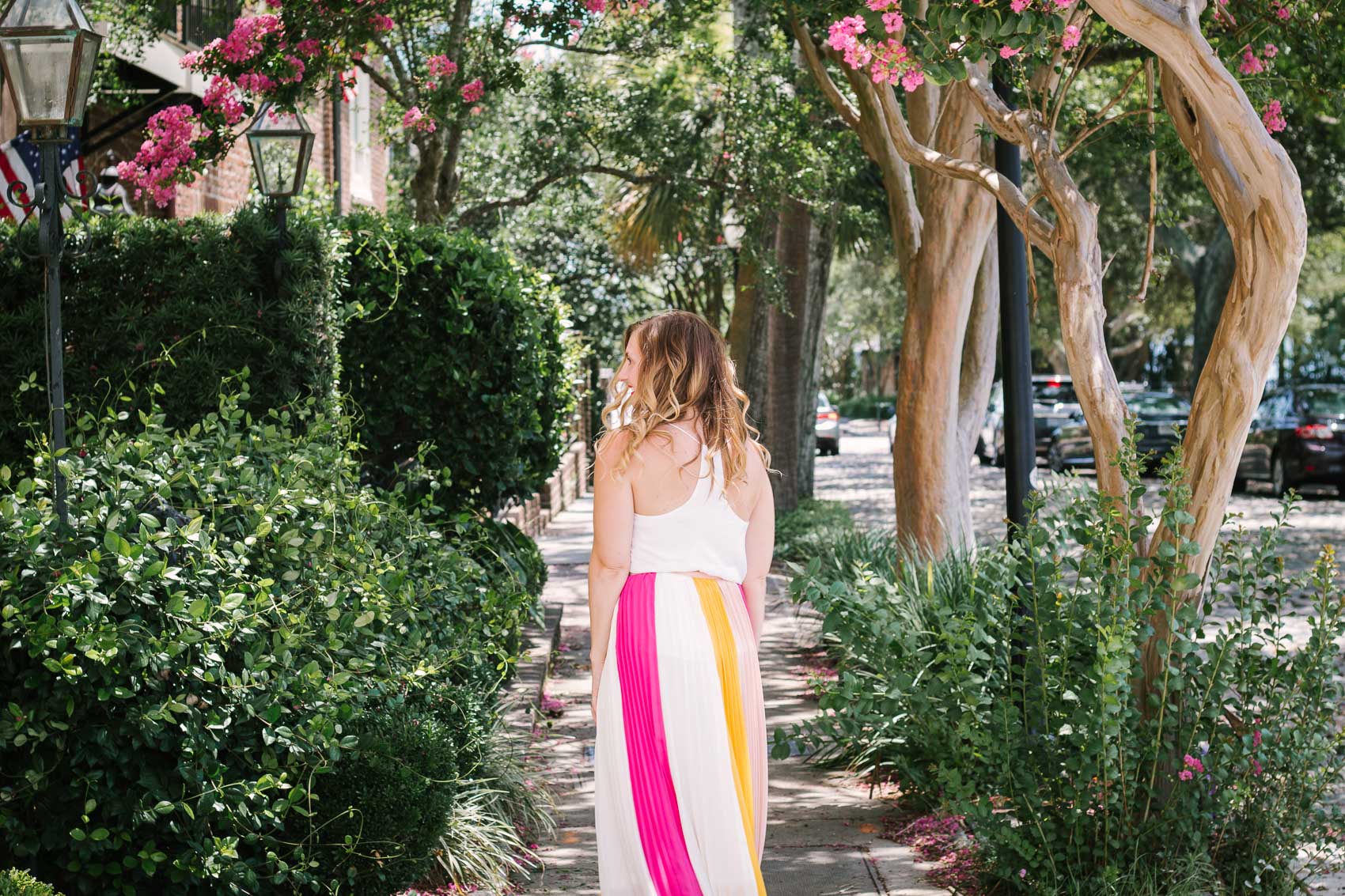 Fashion blogger Allyn Lewis styles a color blocked pleated maxi skirt for a day exploring Charleston, SC. | How to style a pleated maxi skirt | summer outfit inspiration 