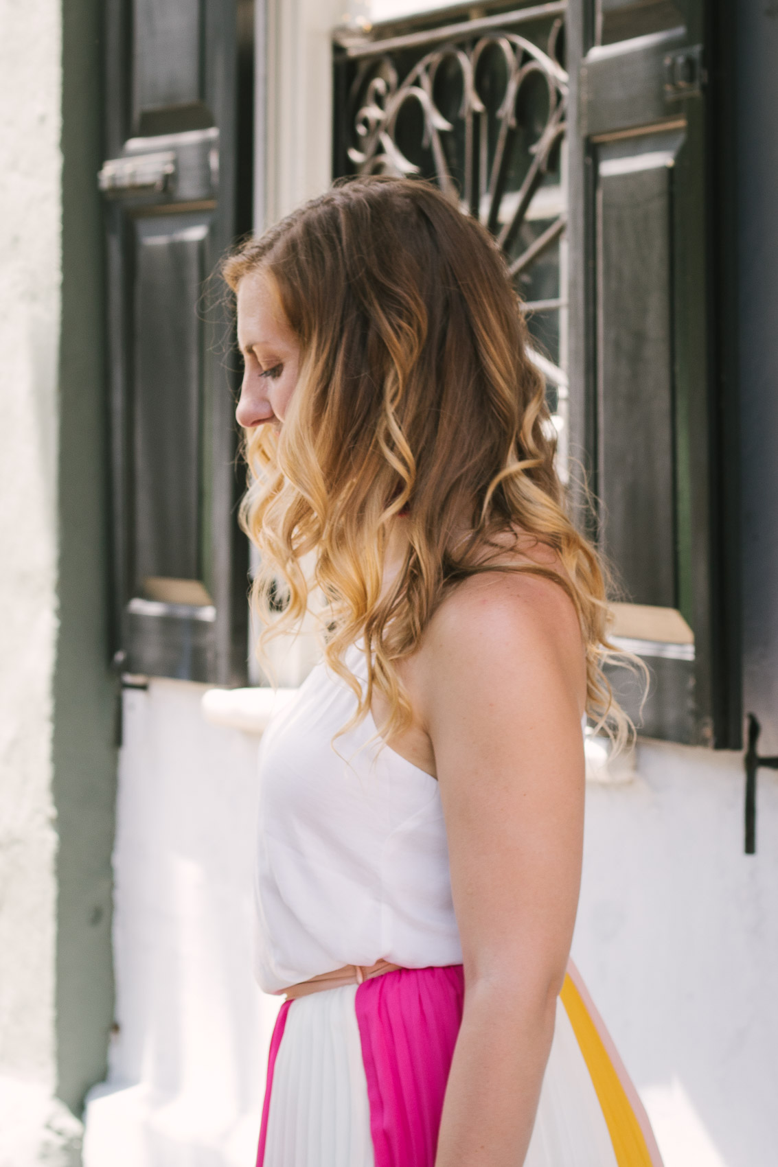 Fashion blogger Allyn Lewis styles a color blocked pleated maxi skirt for a day exploring Charleston, SC. | How to style a pleated maxi skirt | summer outfit inspiration | white cami | easy outfit | everyday outfiit