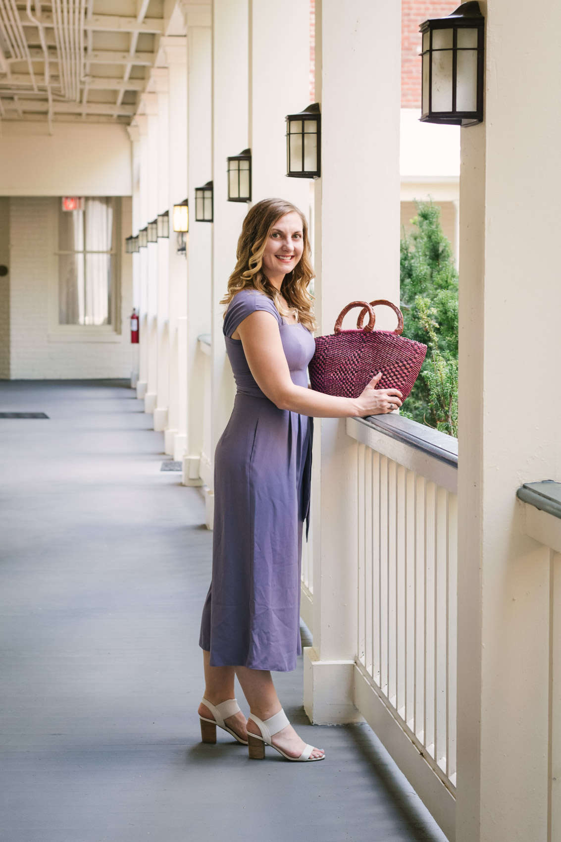 Fashion blogger Allyn Lewis styles the Gal Meets Gal Veronica purple crepe jumpsuit for a casual Summer outfit on a road trip to Linden Row Inn - A historic boutique hotel in Richmond, Virginia