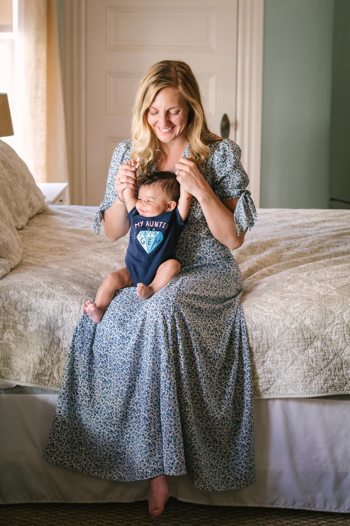 Fashion blogger Allyn Lewis in the Gal Meets Glam Aurora dress with her niece in a "My Auntie is a Total Gem" onesie