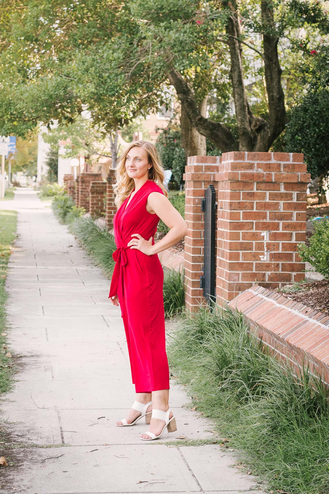 Allyn Lewis from The Gem styles a red jumpsuit from London Times for an elegant, casual outfit while exploring New Bern, NC. 