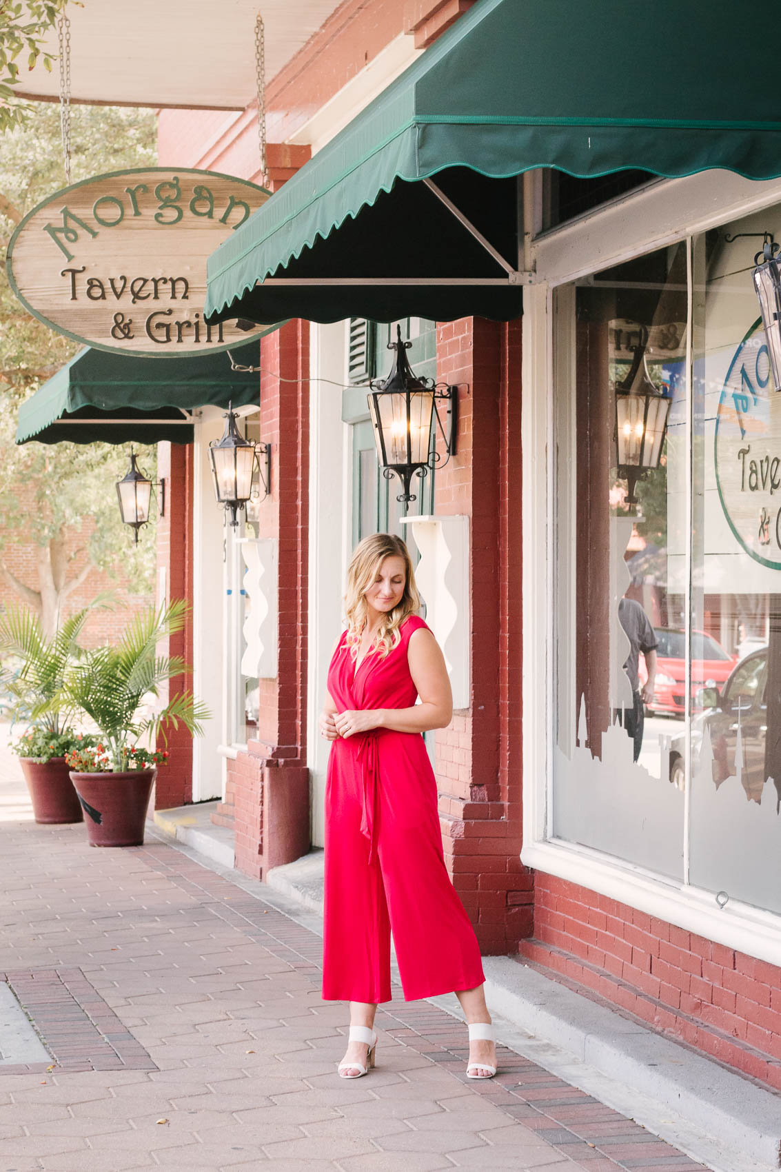 Allyn Lewis from The Gem styles a red jumpsuit from London Times for an elegant, casual outfit while exploring New Bern, NC. 