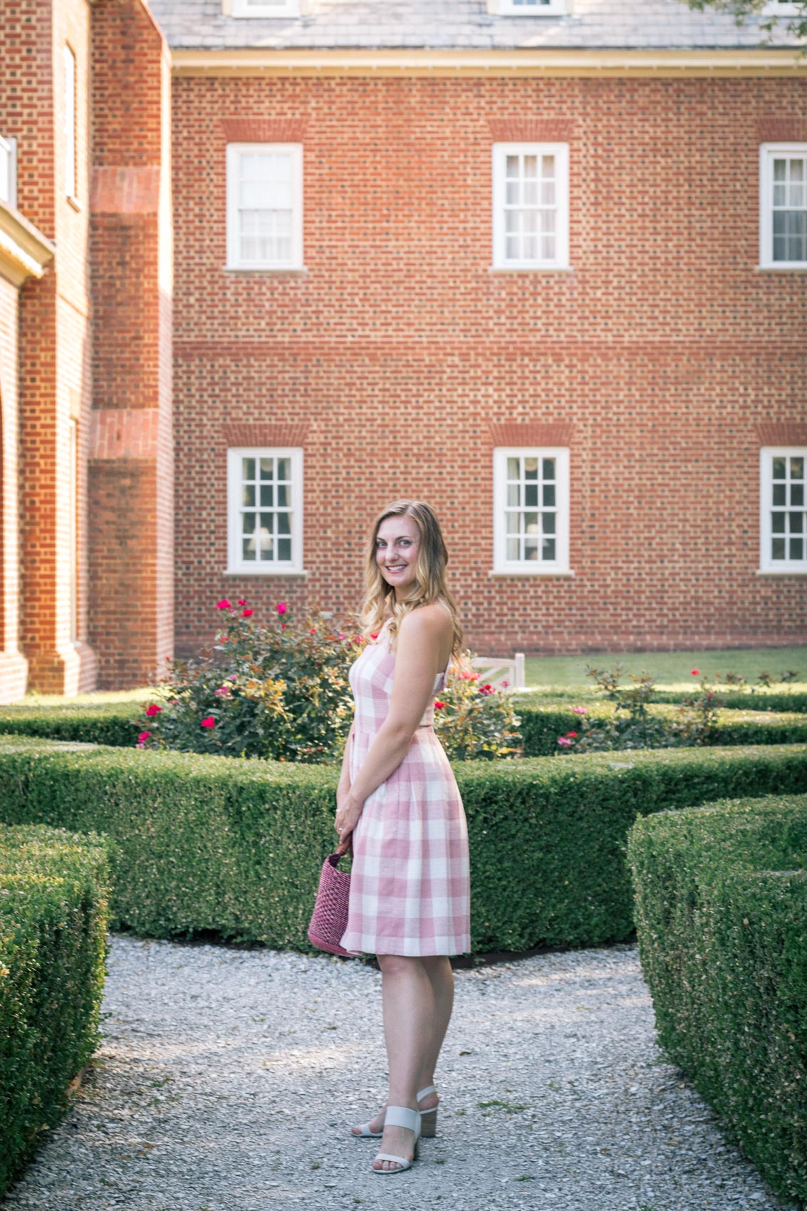 Allyn Lewis of The Gem styles a pink gingham dress from Gal Meets Glam at The Founders Inn & Spa, a Virginia Beach resort and part of the Tapestry Collection by Hilton. 