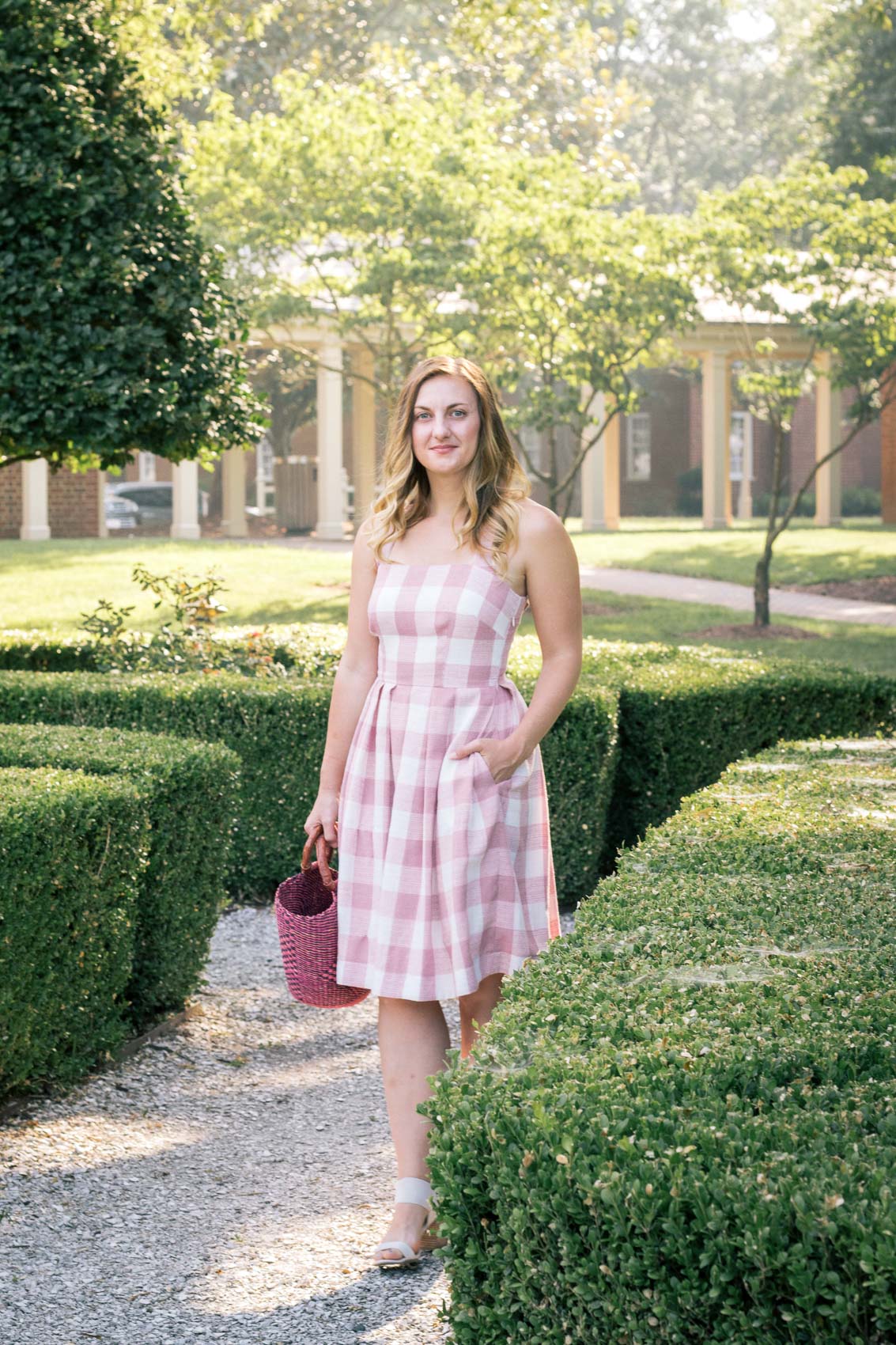 Allyn Lewis of The Gem styles a pink gingham dress from Gal Meets Glam at The Founders Inn & Spa, a Virginia Beach resort and part of the Tapestry Collection by Hilton. 