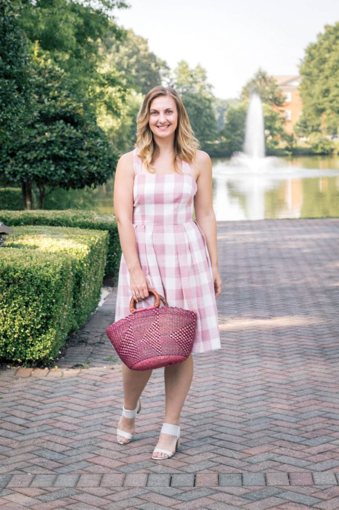 Allyn Lewis of The Gem styles a pink gingham dress from Gal Meets Glam at The Founders Inn & Spa, a Virginia Beach resort and part of the Tapestry Collection by Hilton.