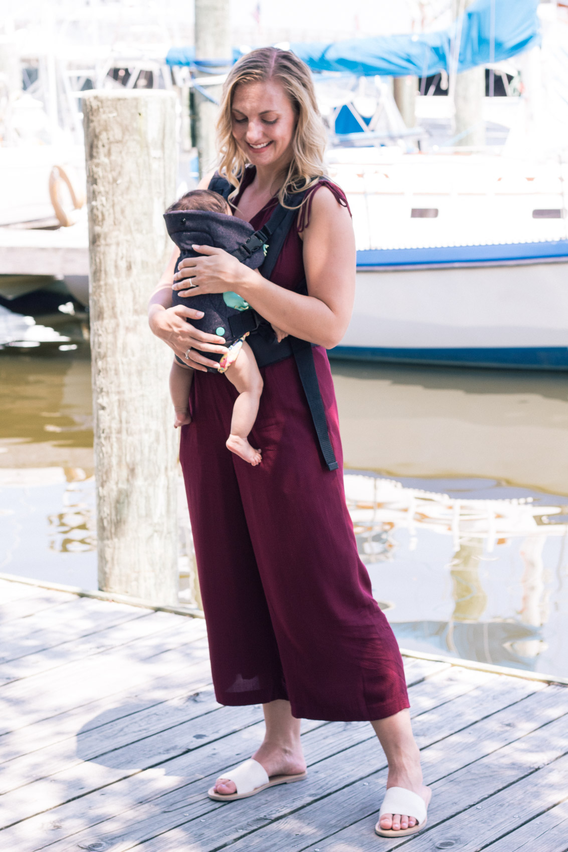 Allyn Lewis styles a burgundy jumpsuit from Gal Meets Glam while exploring Manteo, NC. 