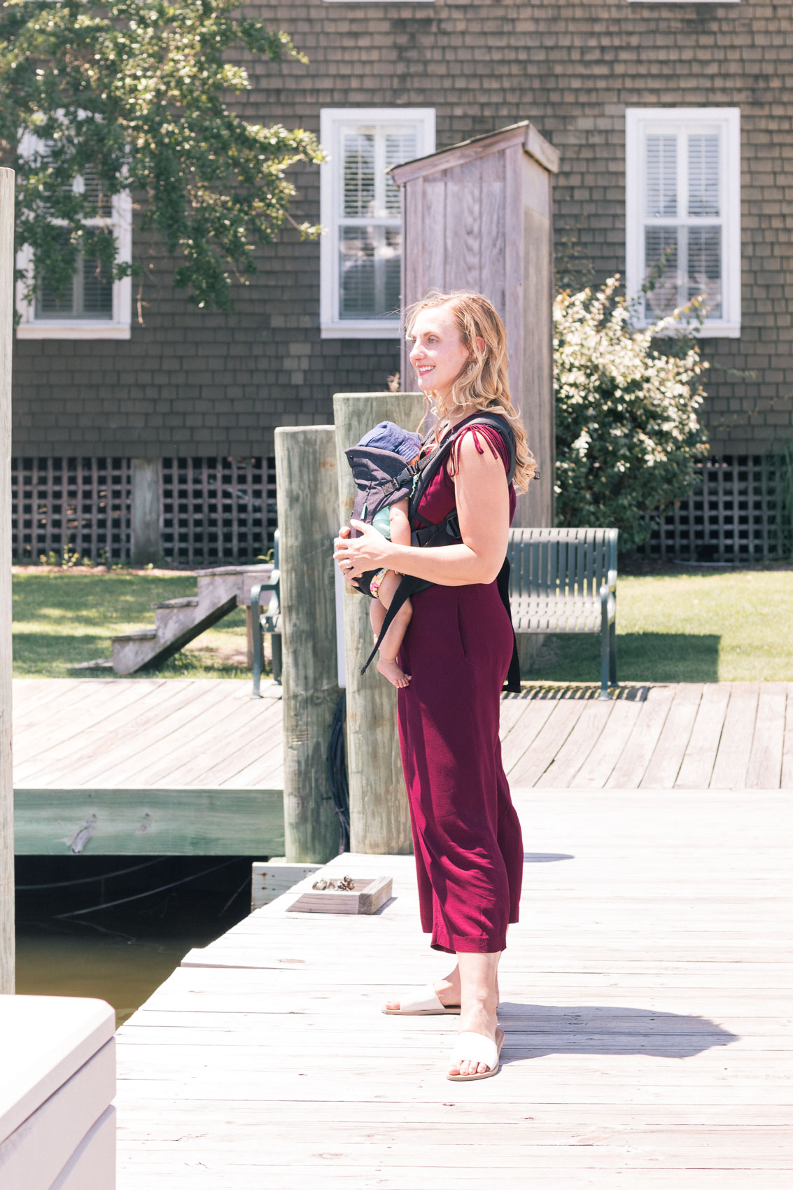 Allyn Lewis styles a burgundy jumpsuit from Gal Meets Glam while exploring Manteo, NC. 