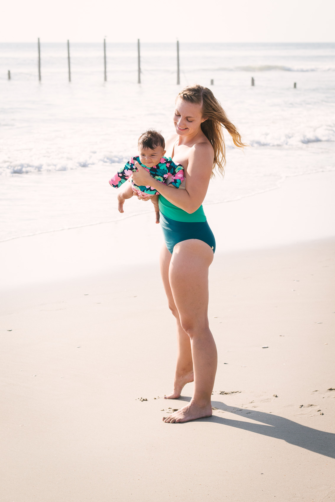 Allyn Lewis wears the Sidestroke one piece bathing suit from Summersalt at the Outer Banks in North Carolina. 
