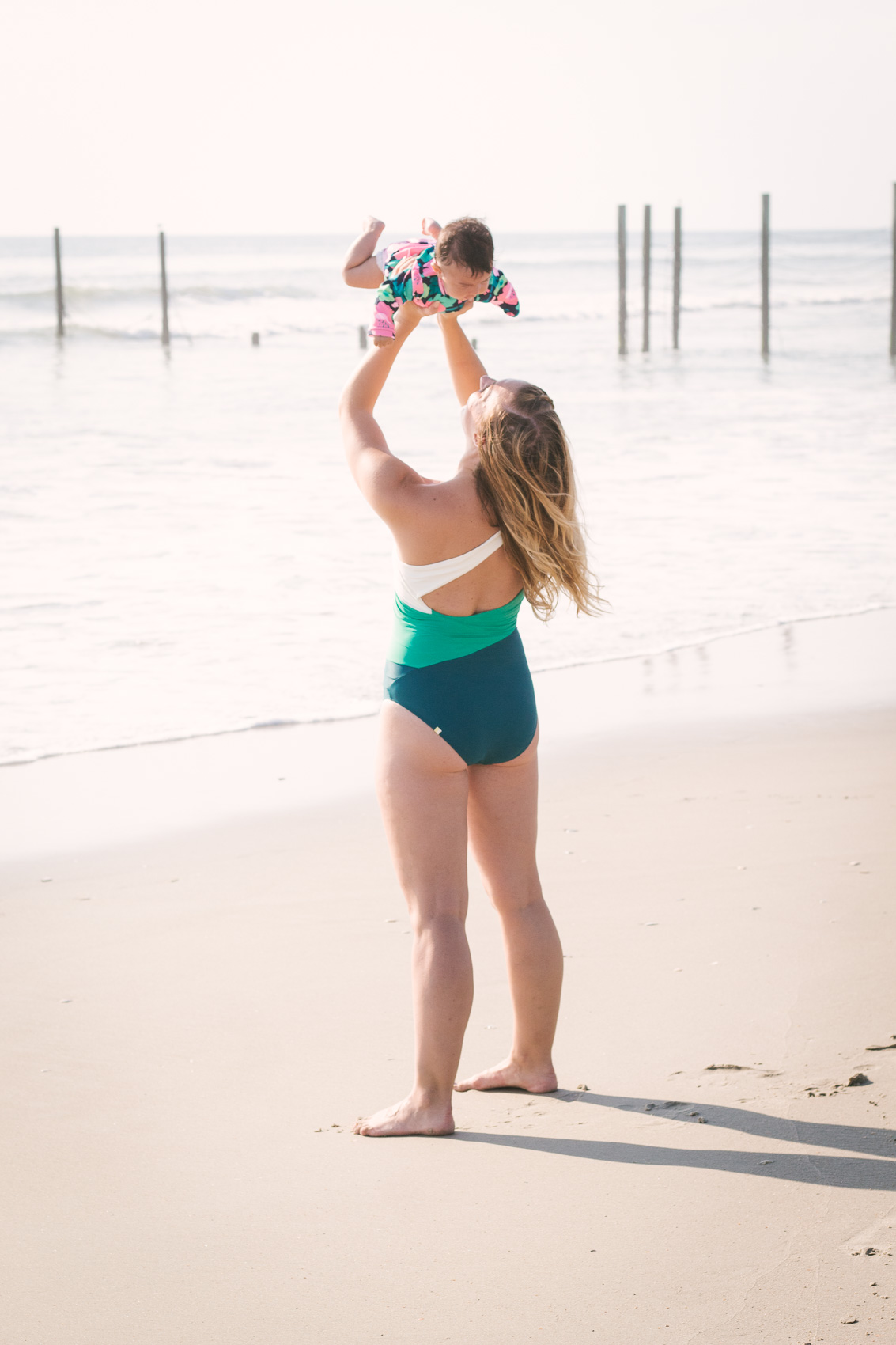 Allyn Lewis wears the Sidestroke one piece bathing suit from Summersalt at the Outer Banks in North Carolina. 