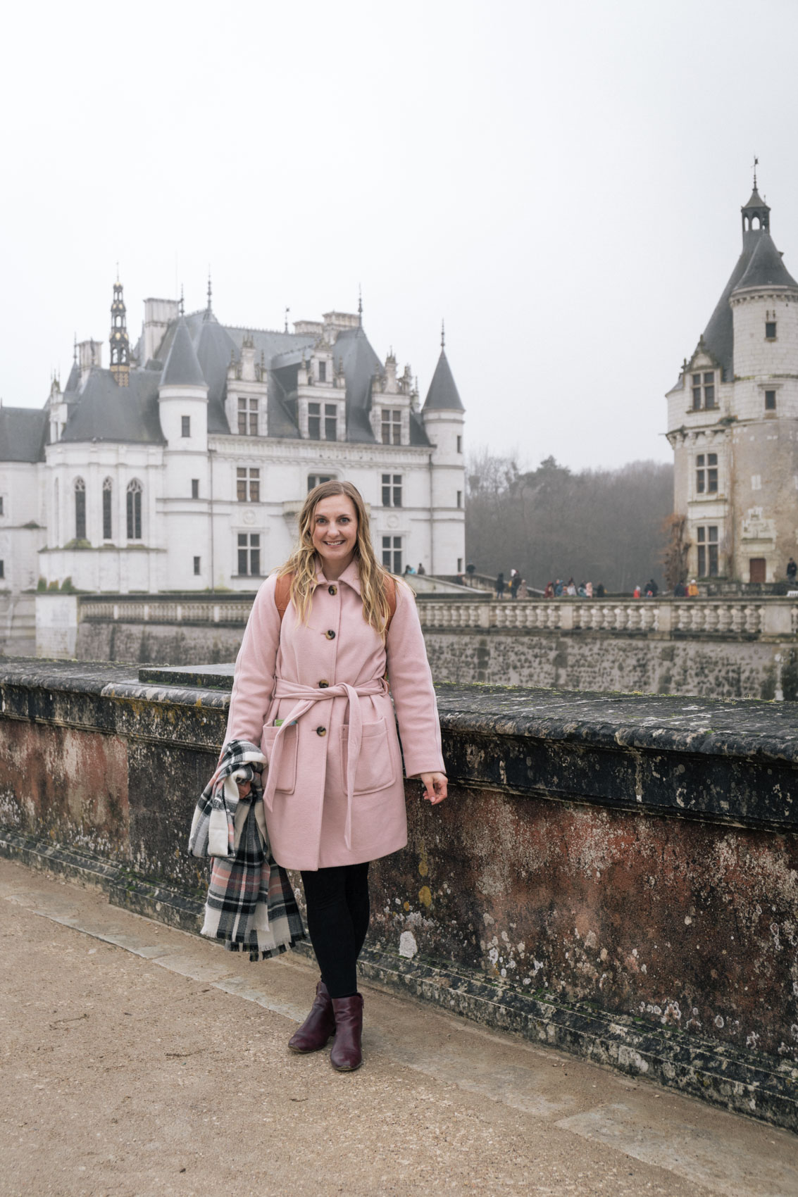 Blush pink coat outfit at a castle in France, Château de Chenonceau. 