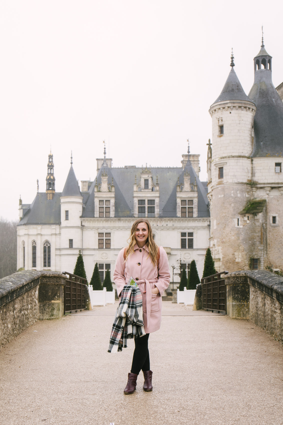 Blush pink coat outfit at a castle in France, Château de Chenonceau. 