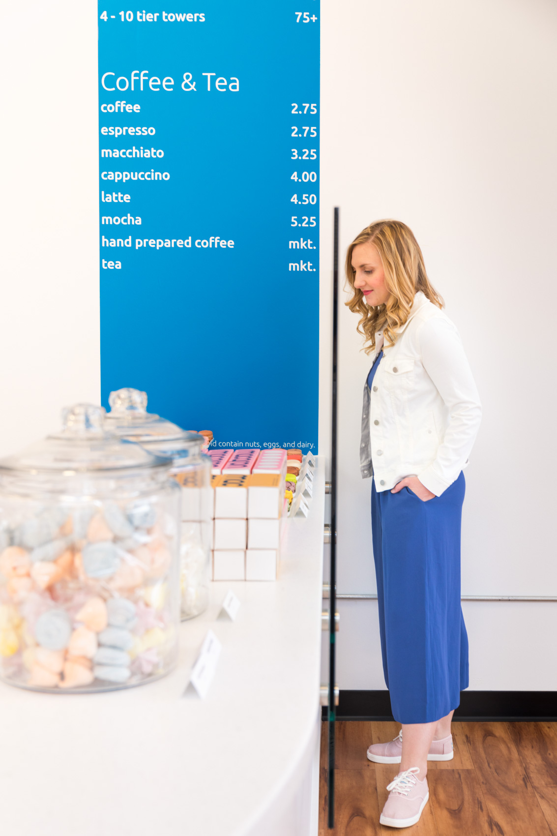 fashion blogger wears casual blue jumpsuit and white denim jacket to Macaron Bar Pittsburgh for an easy spring outfit