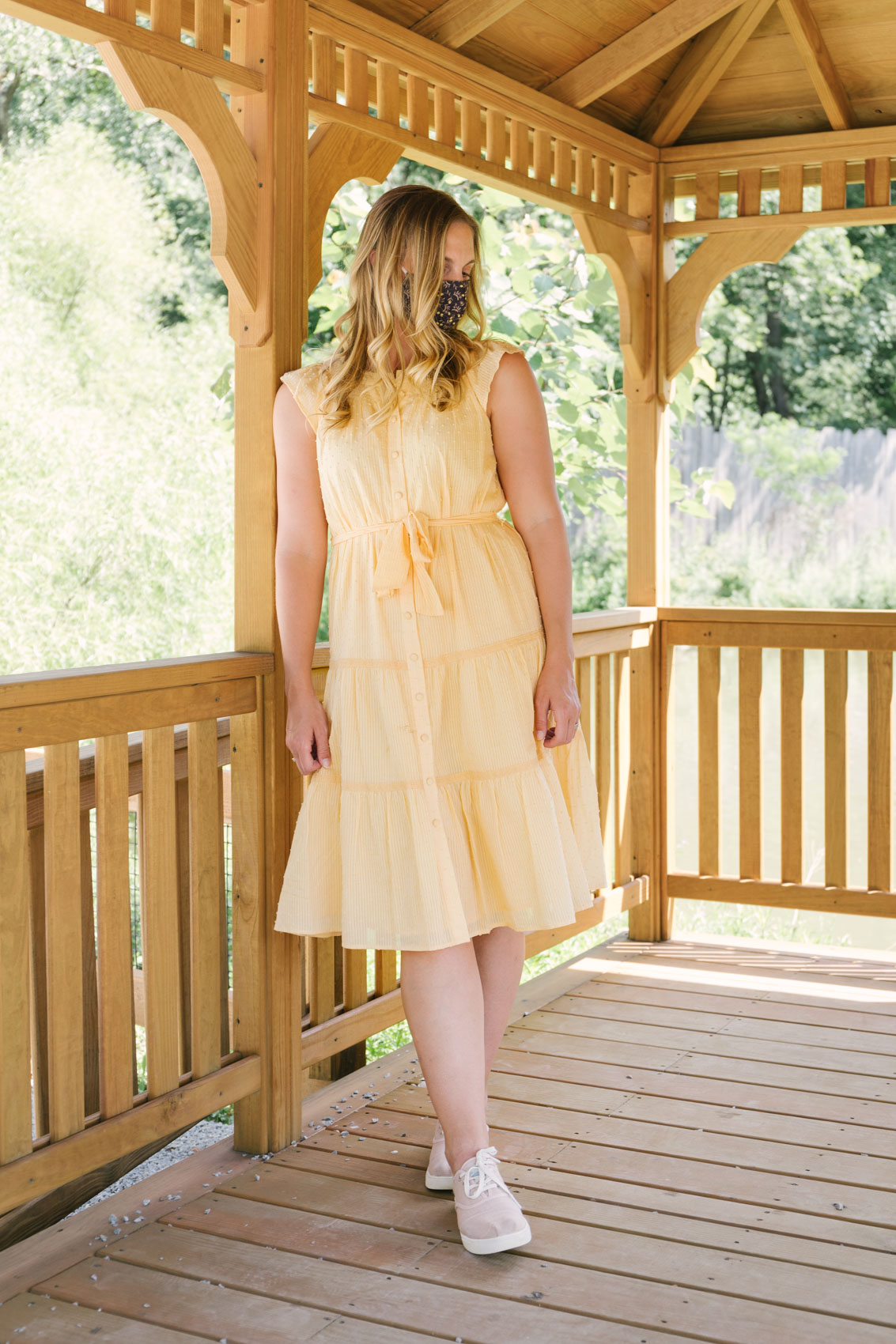 yellow midi dress from Gal Meets Gal Collection styled with pink sneakers for a casual summer outfit. #mididress #dresswithsneakers #casualsummeroutfit