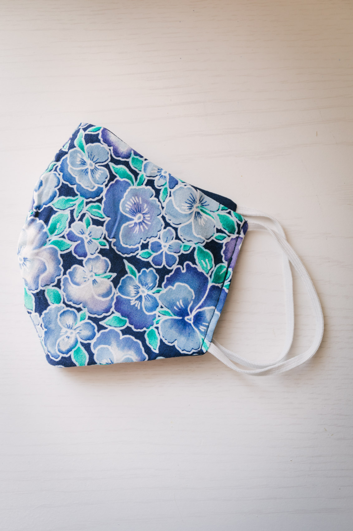 Blue and green washable cotton face mask with filter pocket in a cute floral print by Tidal Cool 