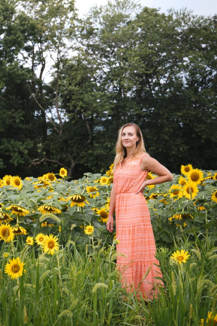 Outfits for sunflower field pictures and photoshoots | wearing a coral maxi dress while shooting at a sunflower field near Pittsburgh, PA