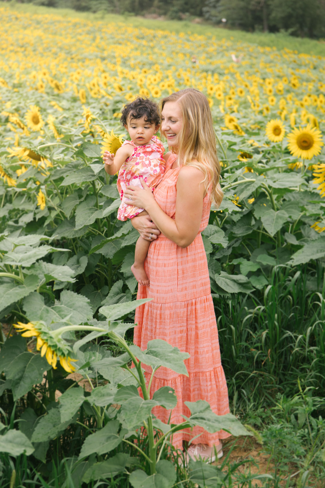 A trip to the sunflower field wearing a coral maxi dress outfit with the Gal Meets Glam Fiona maxi dress. 