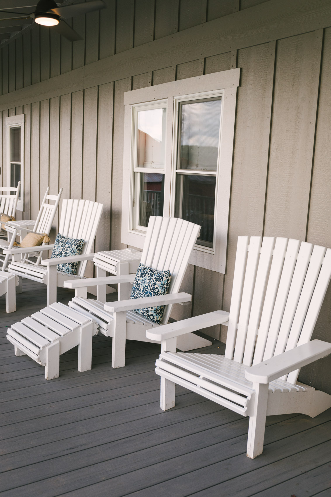 White wooden chairs on the spacious porch at the Red Barn Inn | The Best Place to Stay in Deep Creek Maryland