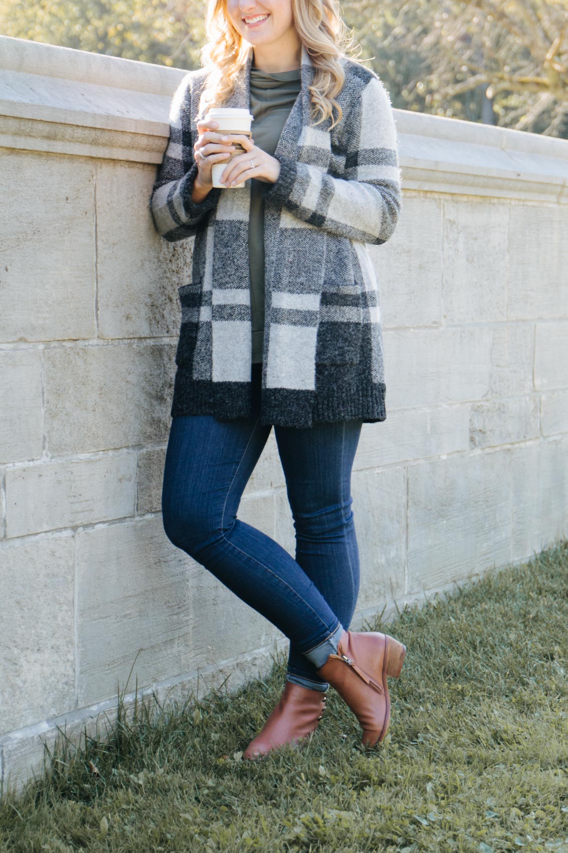 cute fall outfit for 2020 featuring the best ankle boots, dark skinny jeans, and a cozy long cardigan styled by Allyn Lewis