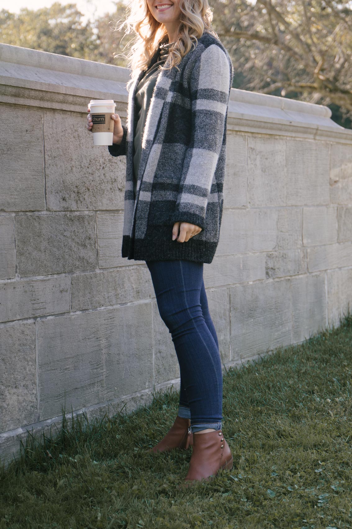 cute fall outfit styled by Allyn Lewis with the best fall ankle booties, stretchy skinny jeans, and a cozy long plaid cardigan