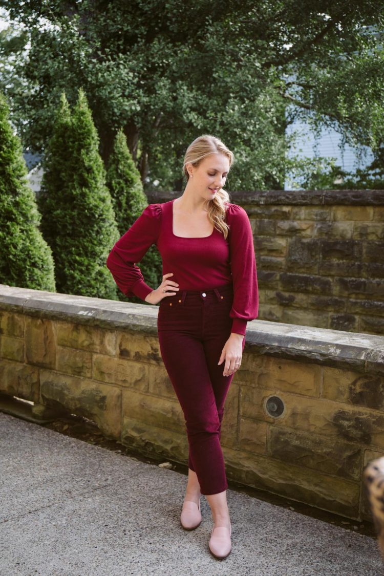 burgundy monochrome look with corduroy straight leg Levi's pants, a burgundy square neck balloon sleeve top, and pink loafers for tonal outfit inspiration
