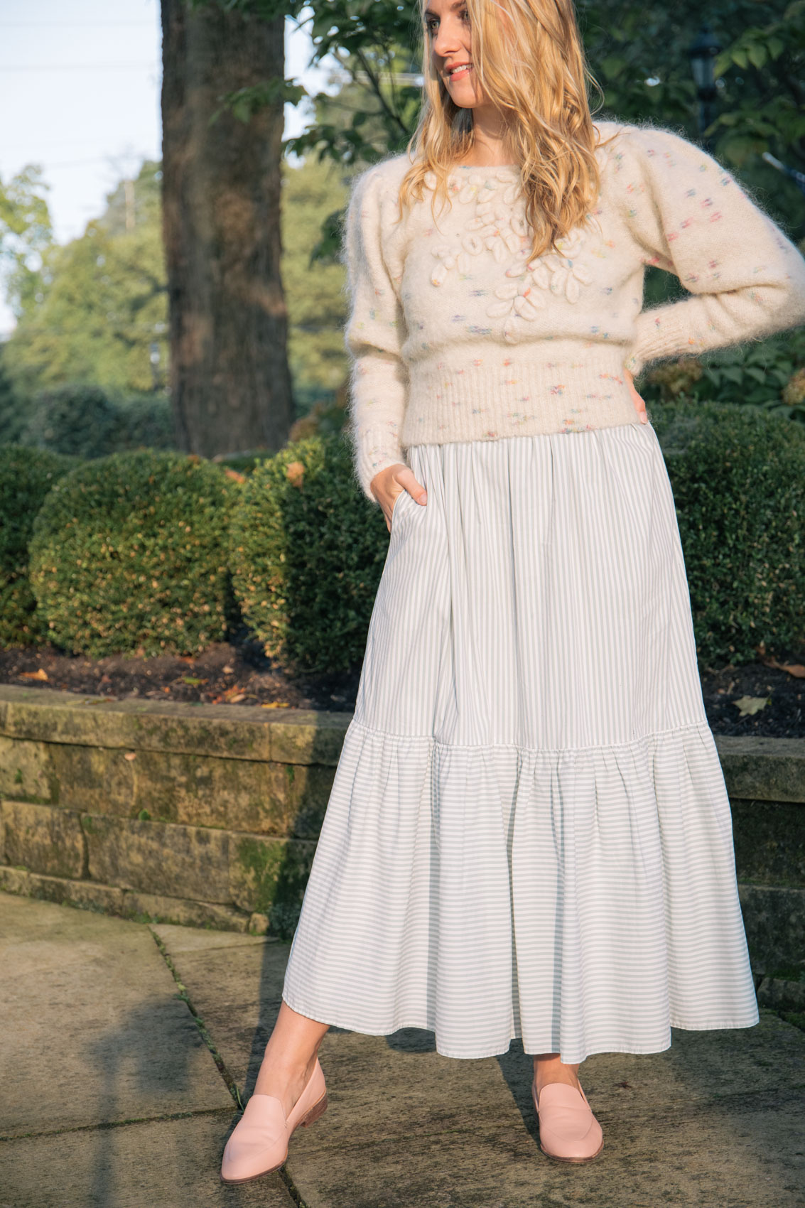 Allyn Lewis styles a cream statement puff sleeve sweater over a maxi dress for a fall 2020 outfit