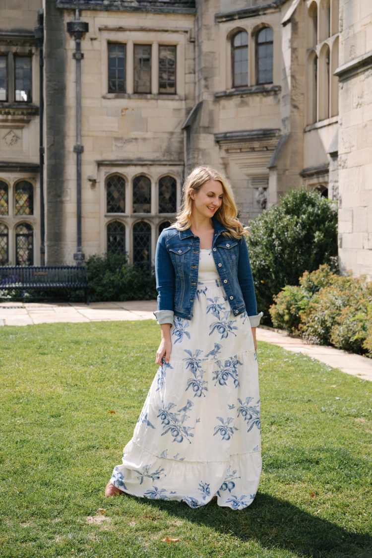 Denim jacket outfit: stretchy Anthropologie denim jacket over a white Agua Bendita maxi dress styled by Allyn Lewis