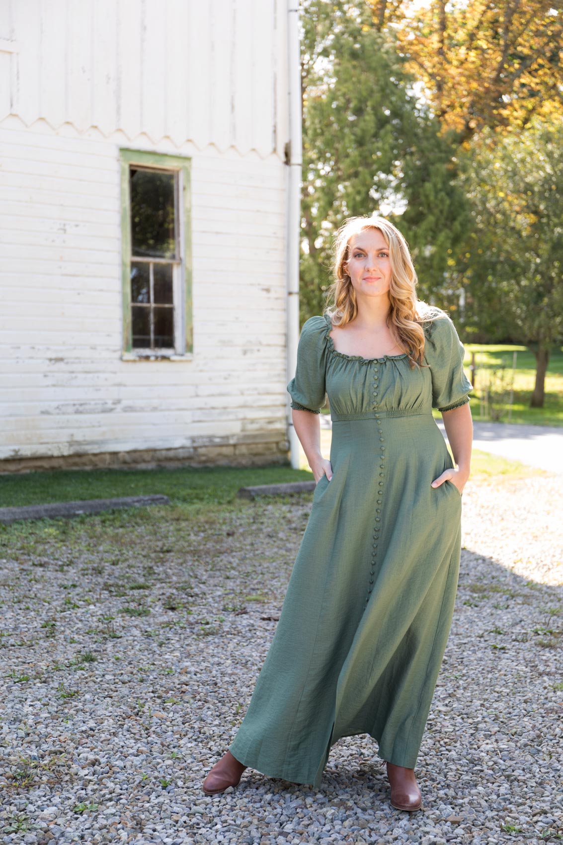 Allyn Lewis in the green puff sleeve Gal Meets Glam Joanna dress and brown ankle booties from Sam Edelman. 