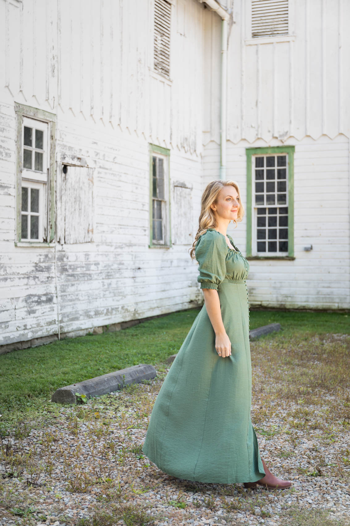 Allyn Lewis styles an elegant outfit with a green puff sleeve dress and brown ankle booties 