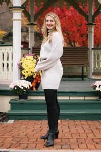 fashion blogger Allyn Lewis styles a grey sweater dress from Amazon with a belt, tights, and ankle booties.