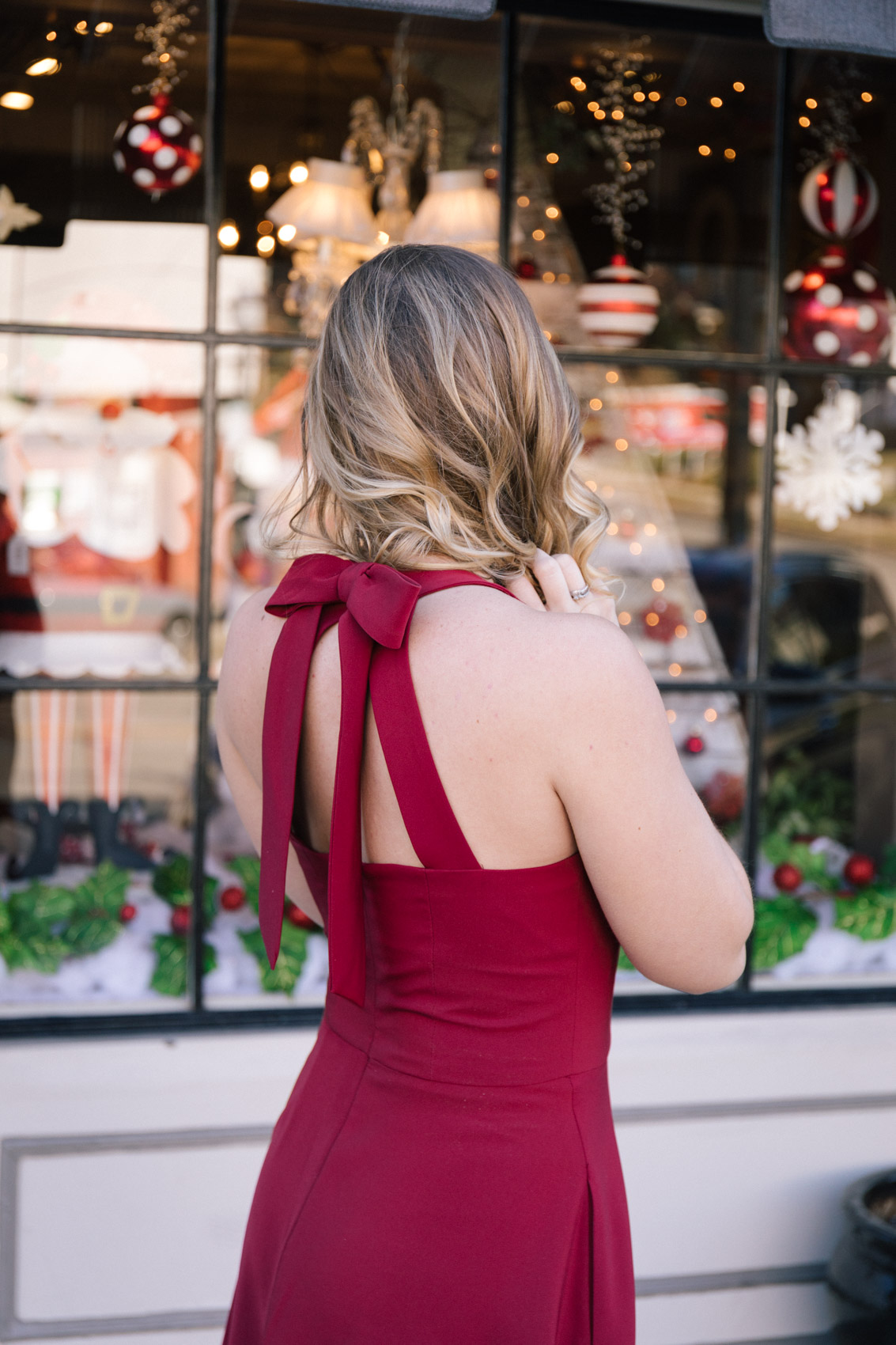 A red holiday dress featuring a bow back detail. 