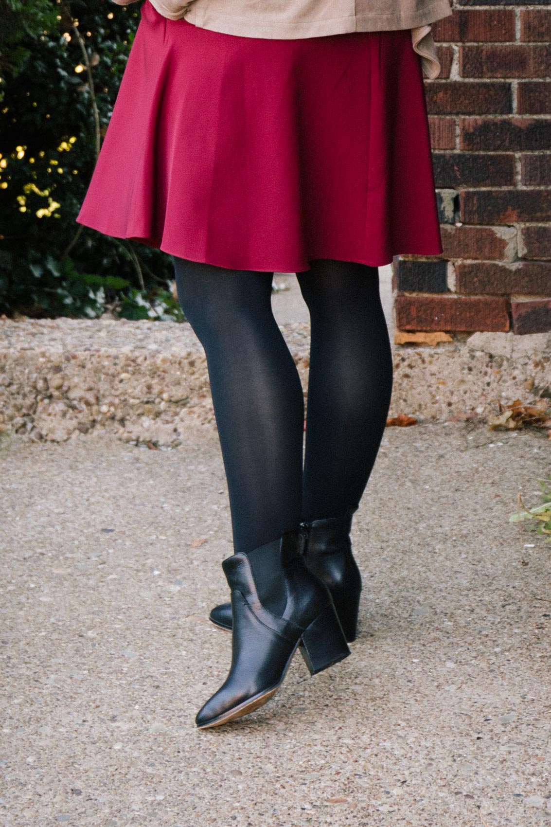 Red Christmas dress outfit styled with black ankle boots and tights. 