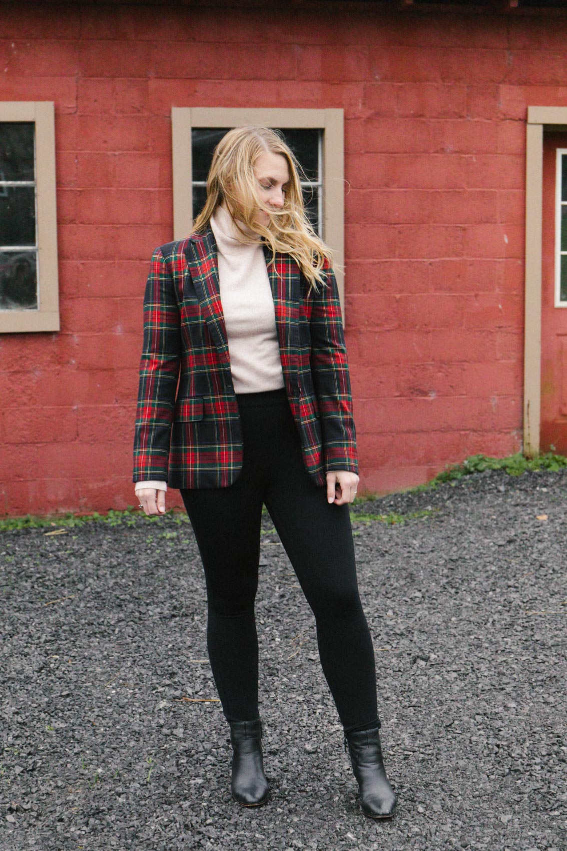 Trendy blazer outfit with a plaid suit jacket over a turtleneck sweater paired with Spanx black pants and ankle boots