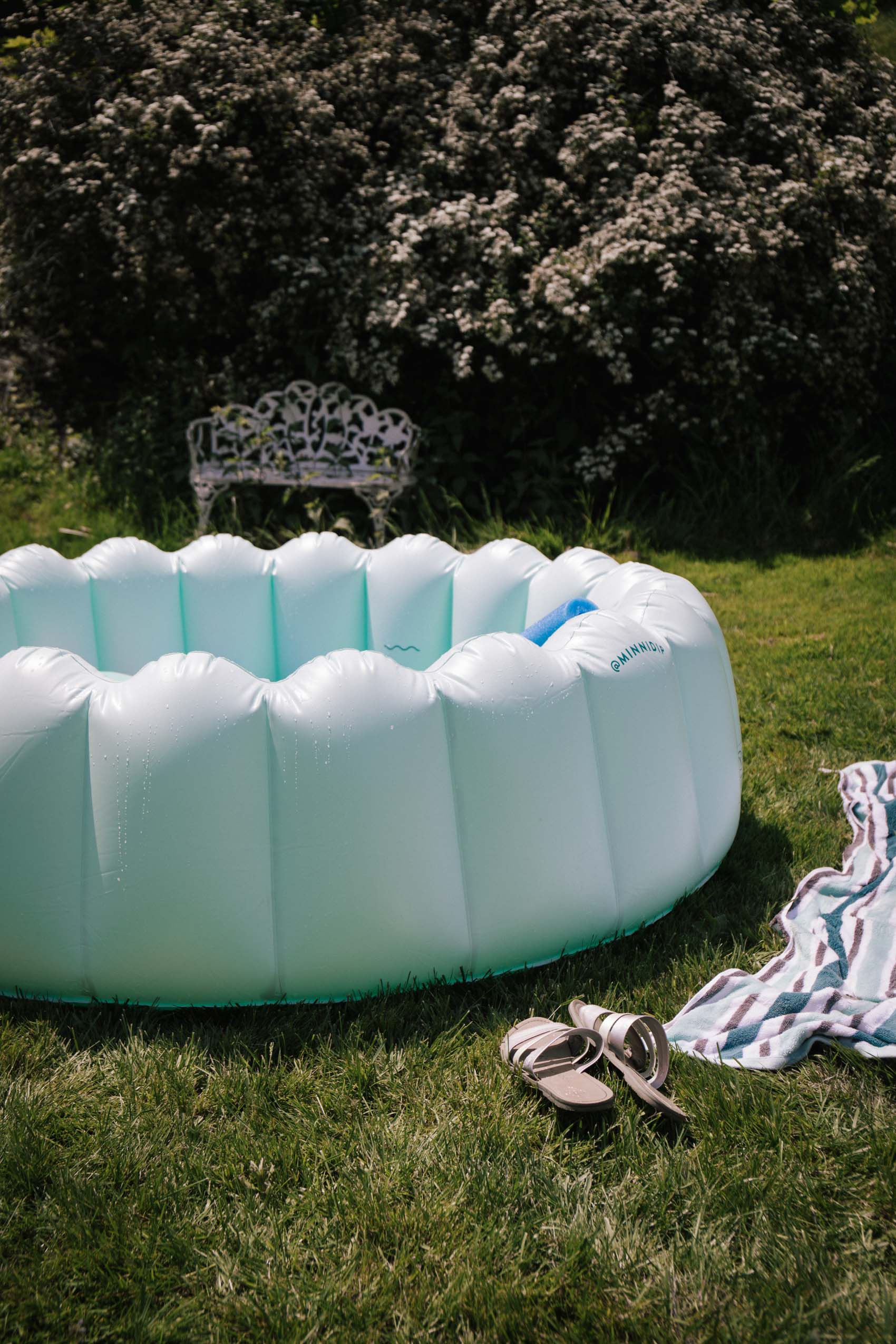 mint green inflatable kiddle pool in backyard