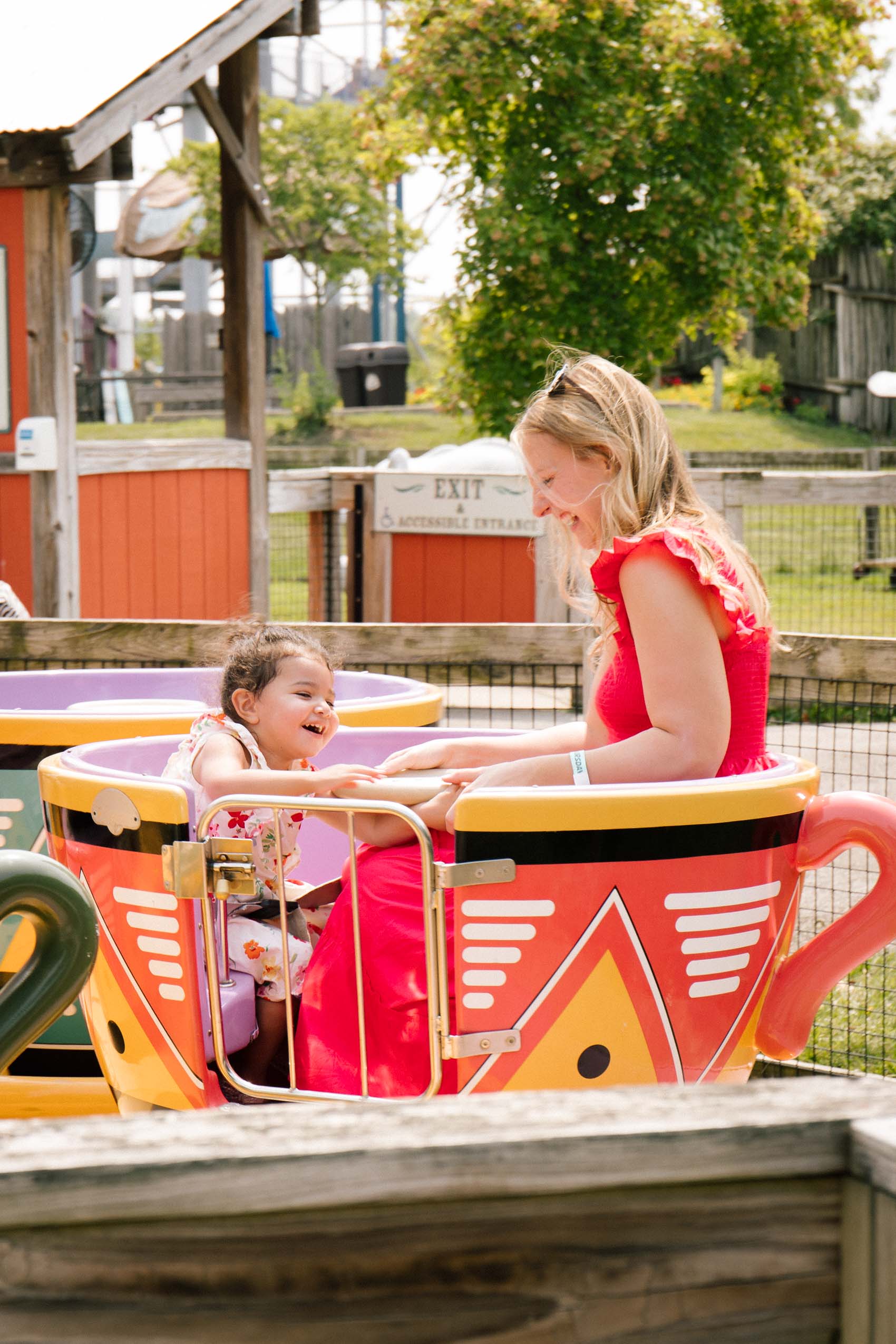 Woman and child on a teacup ride