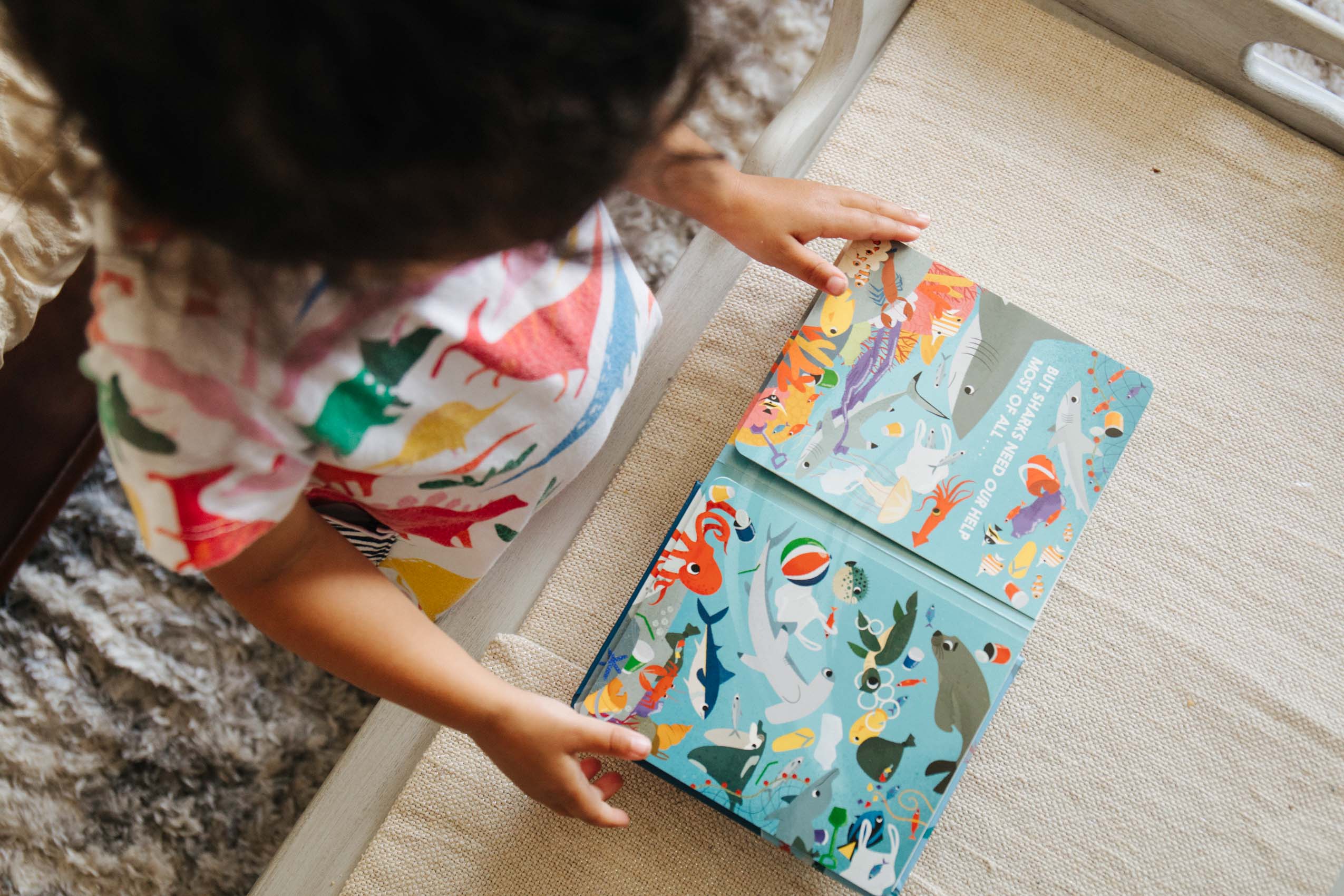 Toddler reading a board book about sharks