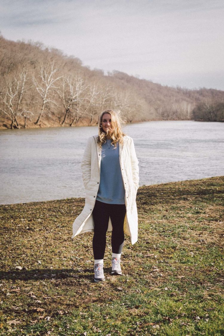 Winter Style: An easy long puffer jacket outfit featuring a thrifted white quilted jacket, waffle knit sweatshirt, cozy crew socks, and Ryka trail boots.