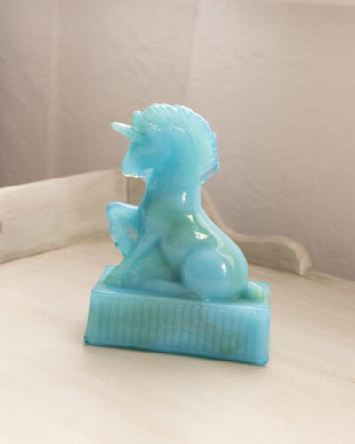 This whimsical vintage R. Wetzel blue slag glass unicorn adds a touch of enchantment to any space.