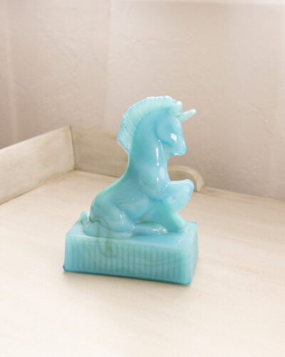 This whimsical vintage R. Wetzel blue slag glass unicorn adds a touch of enchantment to any space.