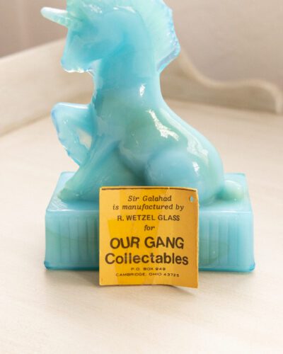 This whimsical vintage R. Wetzel blue slag glass unicorn adds a touch of enchantment to any space.