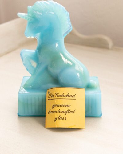 This whimsical vintage R. Wetzel blue slag glass unicorn adds a touch of enchantment to any space.