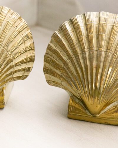 Pair of brass shell bookends with beige details